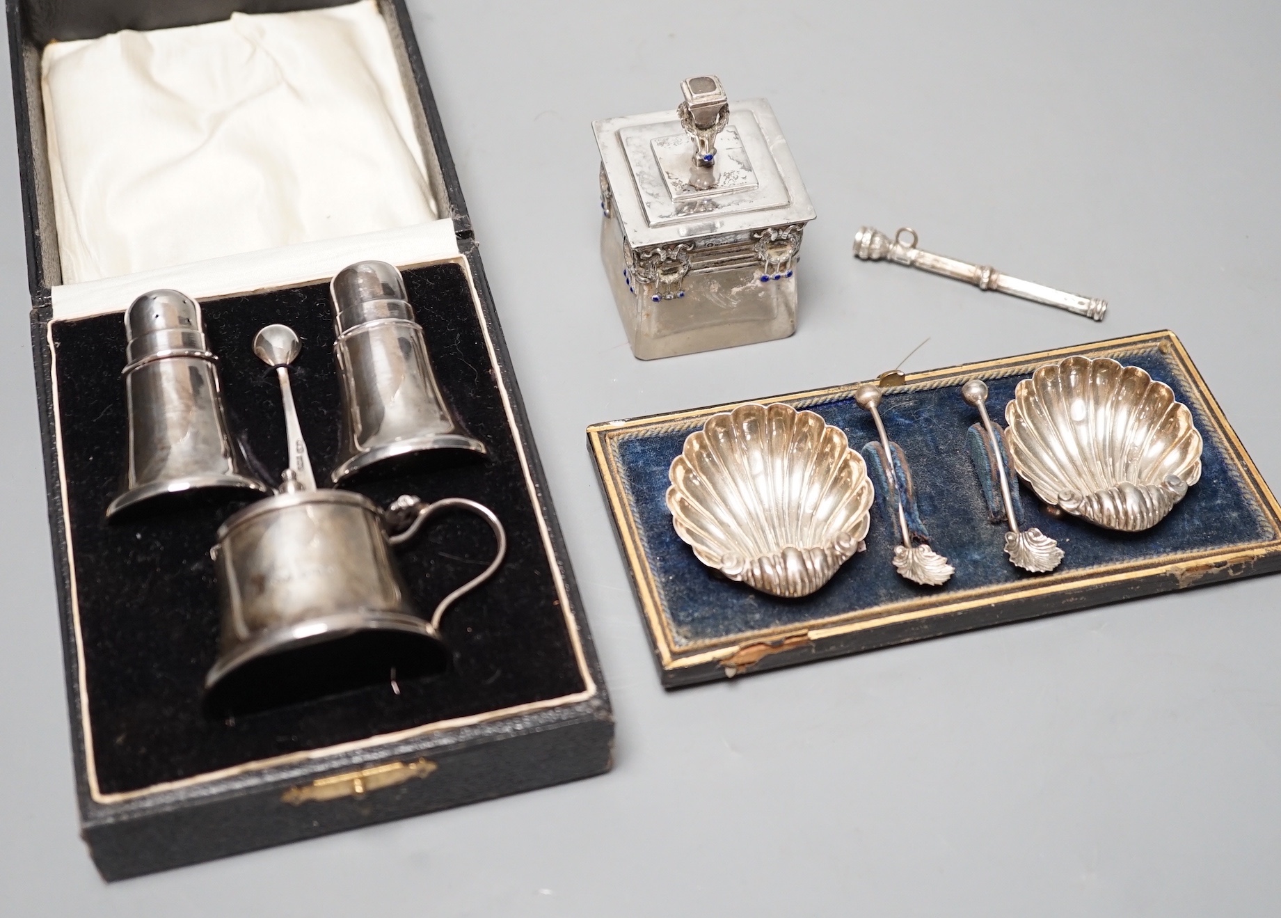 An Austro-Hungarian and enamel mounted glass pot and cover, a cased pair of silver shell salts, a propelling pencil and a cased silver three piece cruet set.